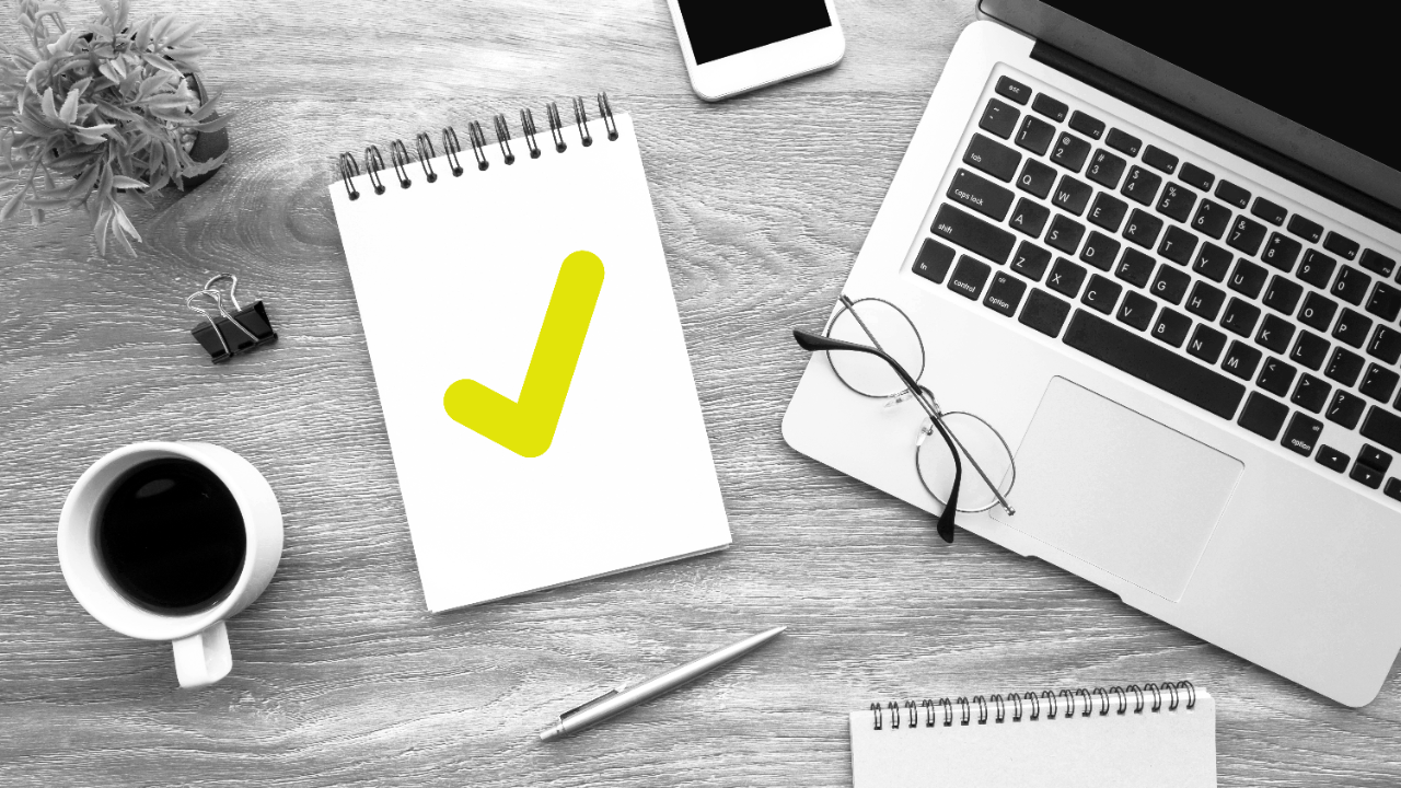 Table with office supplies including a notepad with the Register to Vote checkmark